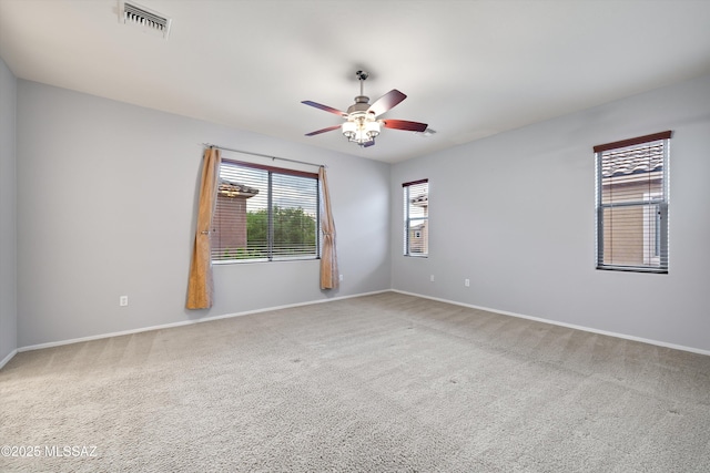 carpeted spare room with ceiling fan