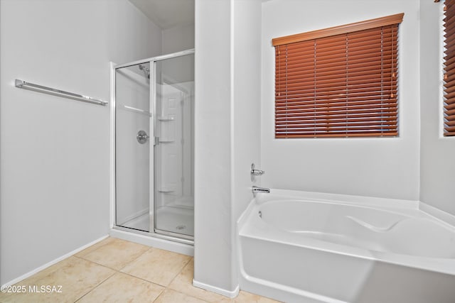 bathroom with tile patterned flooring and separate shower and tub