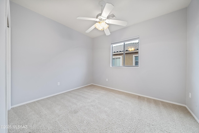 empty room featuring carpet floors and ceiling fan