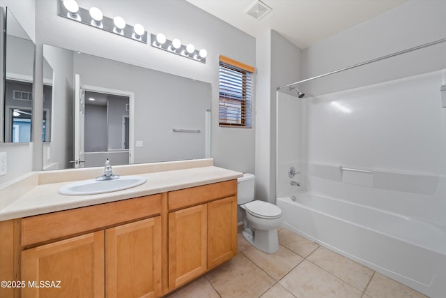 full bathroom with vanity, tile patterned floors, washtub / shower combination, and toilet
