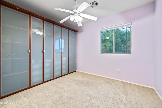 unfurnished bedroom featuring carpet floors and ceiling fan