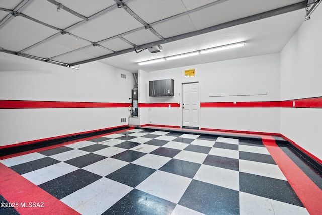 garage with a garage door opener and water heater