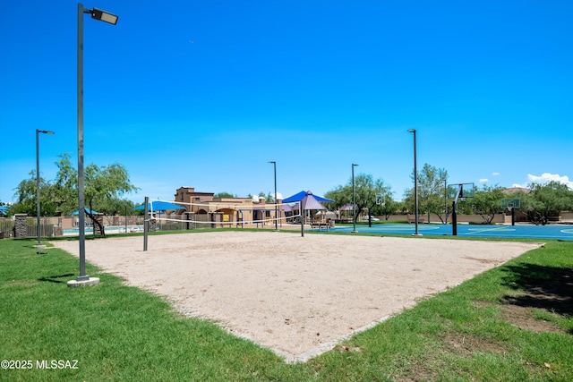 view of property's community with a yard, volleyball court, and basketball hoop