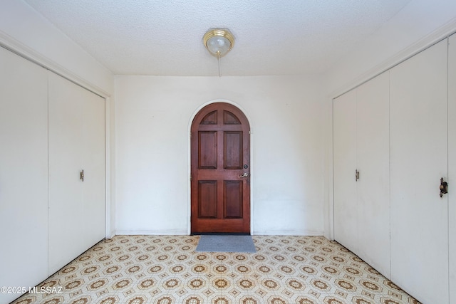 entryway featuring a textured ceiling