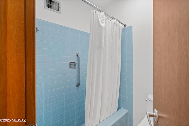 bathroom with toilet and shower / bathtub combination with curtain