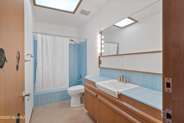 bathroom featuring vanity, backsplash, and toilet