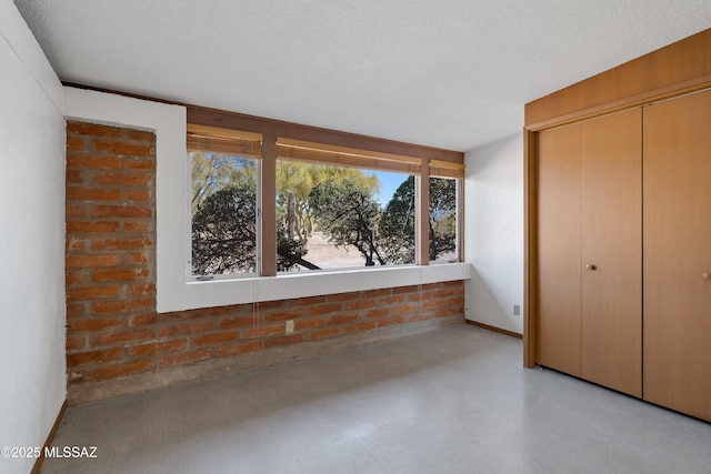 unfurnished bedroom with a closet and a textured ceiling