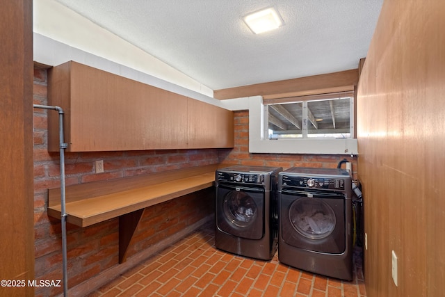 washroom featuring washer and dryer and a textured ceiling