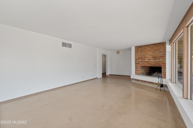 unfurnished living room featuring a fireplace and a textured ceiling