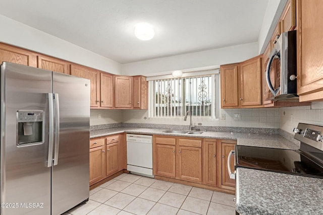 kitchen featuring backsplash, light countertops, light tile patterned floors, stainless steel appliances, and a sink