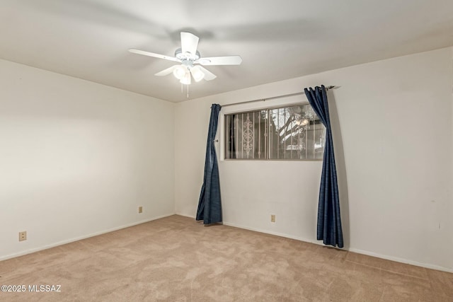 empty room featuring light carpet and ceiling fan