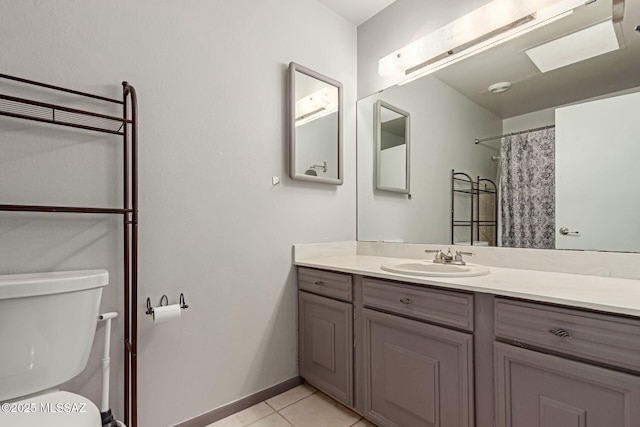 bathroom with a shower with curtain, tile patterned floors, toilet, and vanity