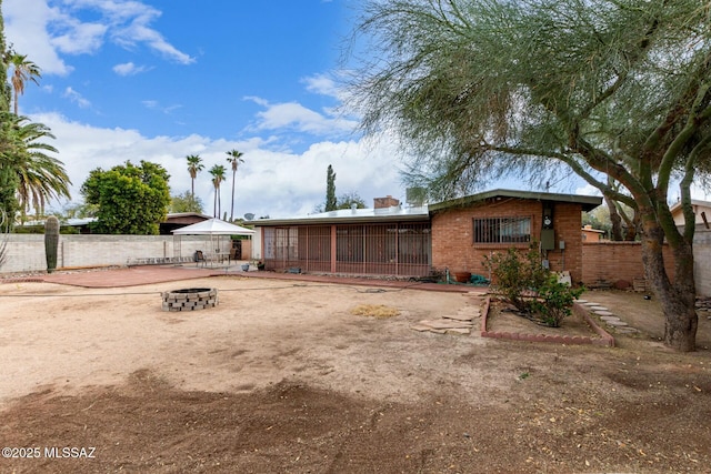 rear view of house with a fire pit