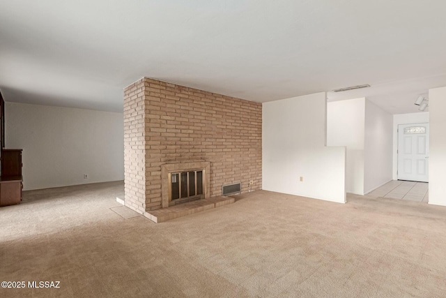 unfurnished living room with light colored carpet and a fireplace