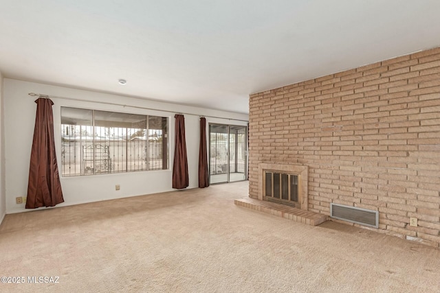 unfurnished living room with a fireplace and light colored carpet