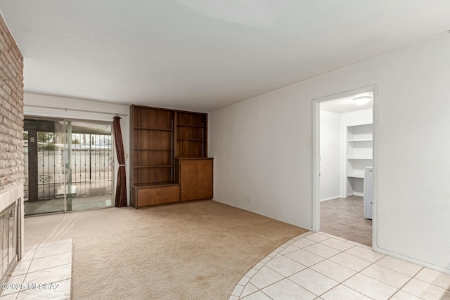 unfurnished living room featuring light carpet