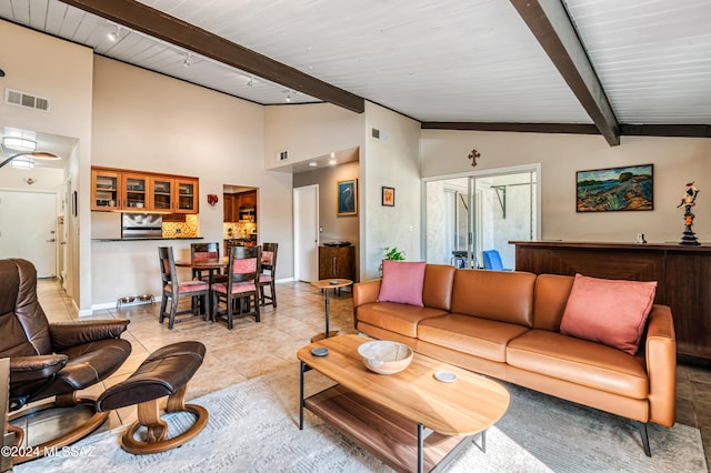 tiled living room with vaulted ceiling with beams