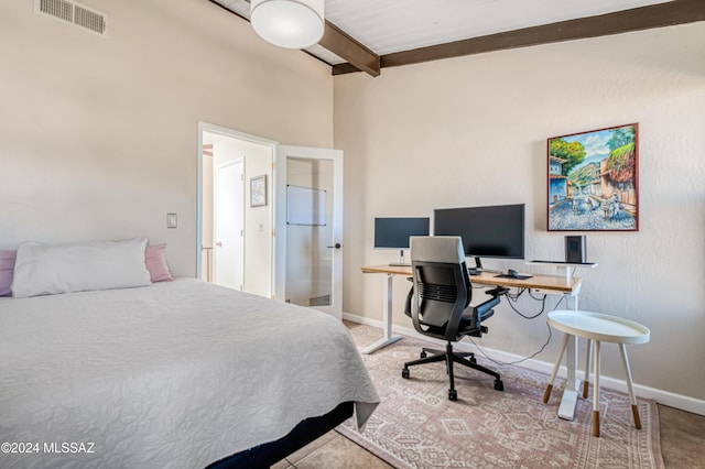 bedroom featuring beamed ceiling and french doors