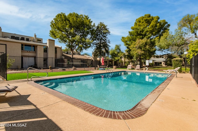 view of swimming pool featuring a patio area