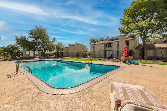 view of swimming pool with a patio