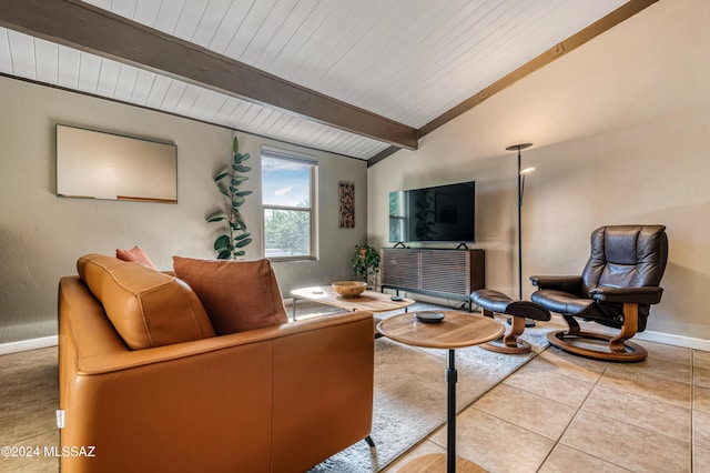 living room featuring vaulted ceiling with beams and light tile patterned floors