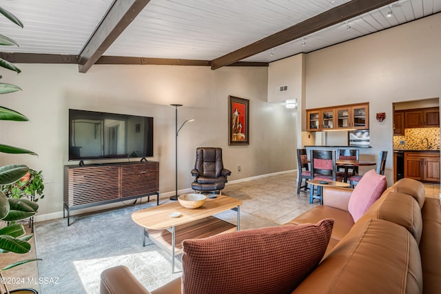 living room with sink and lofted ceiling with beams