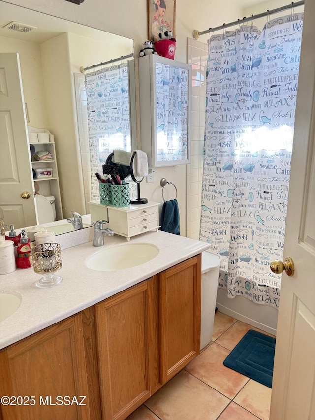 full bathroom featuring vanity, shower / tub combo, tile patterned floors, and toilet