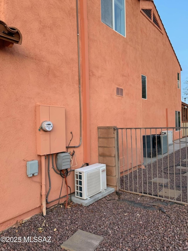 view of side of home with ac unit