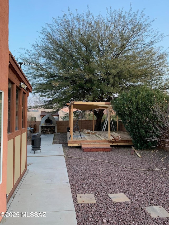 view of yard featuring a wooden deck and a patio area