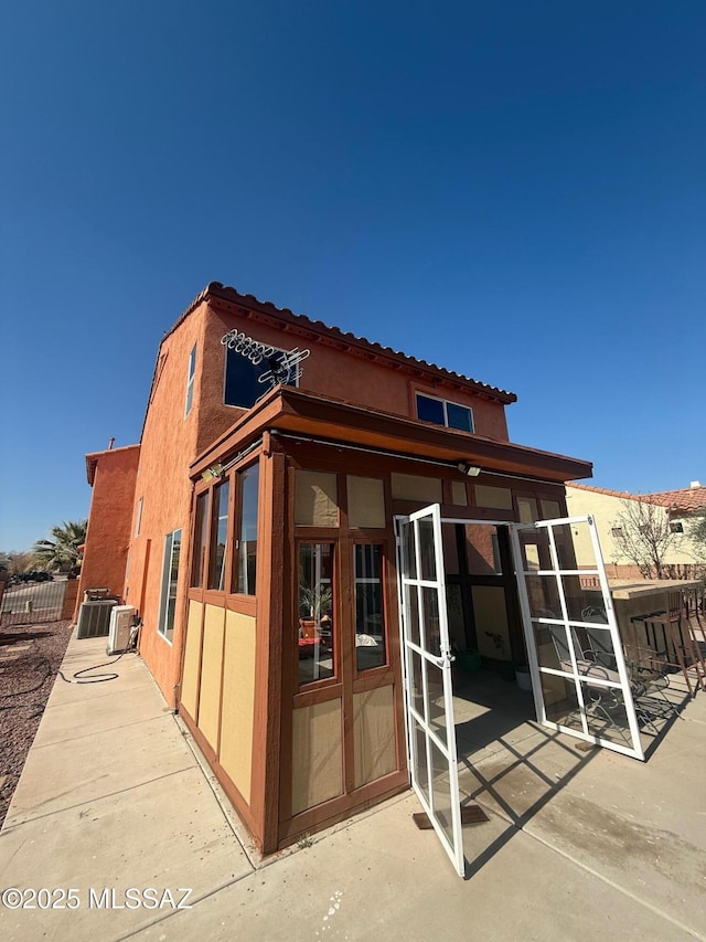 view of side of property with a patio and french doors