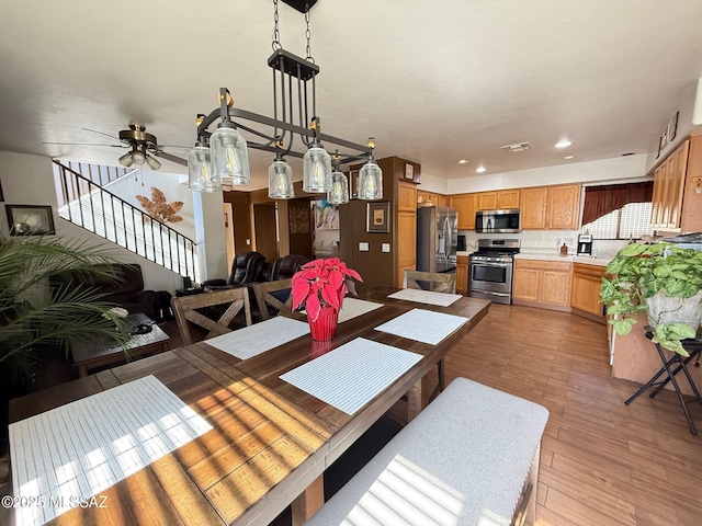 dining area with ceiling fan and hardwood / wood-style floors