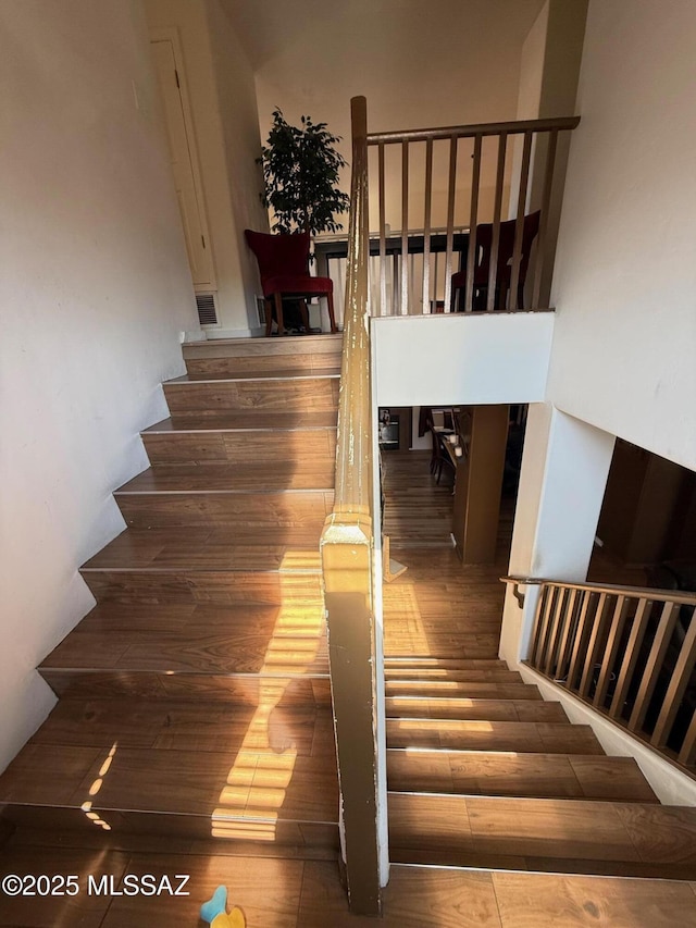 stairs with wood-type flooring