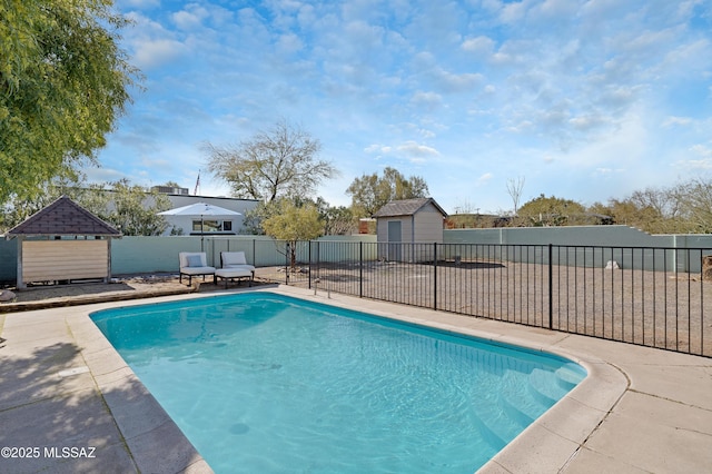 view of pool with a shed