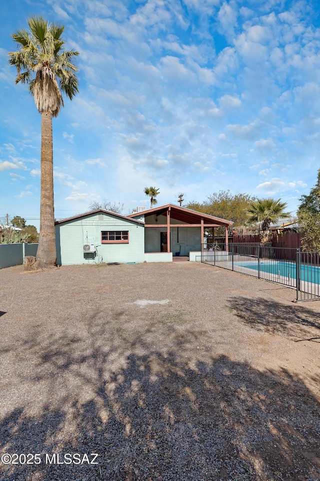 exterior space featuring a fenced in pool and a patio area