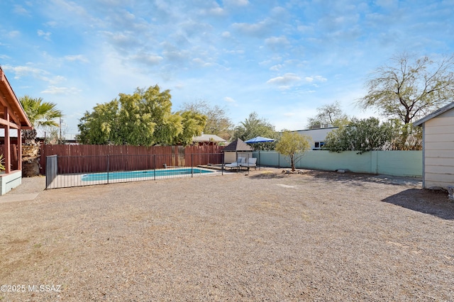 view of yard featuring a fenced in pool and a gazebo