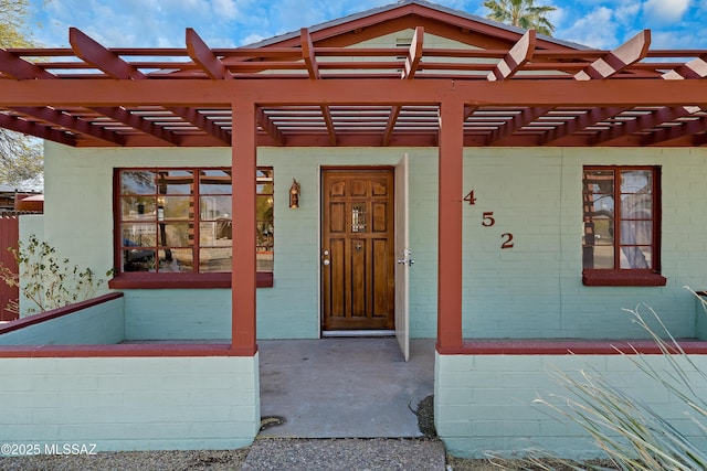 entrance to property featuring a pergola