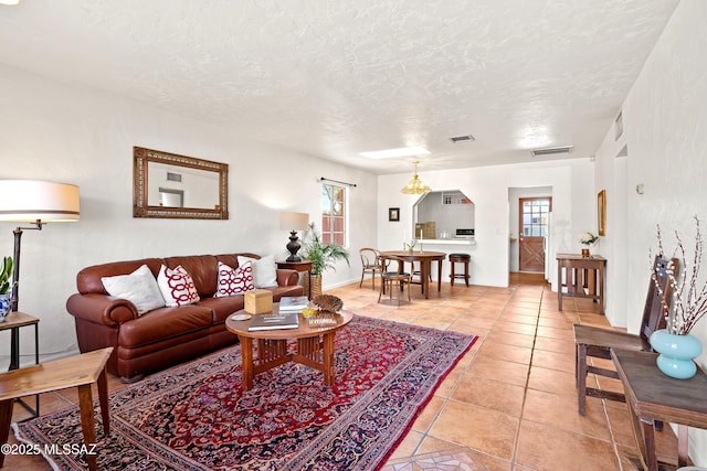 tiled living room with a textured ceiling