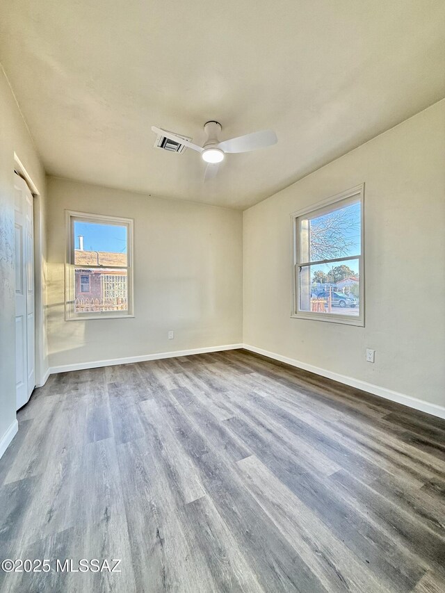 unfurnished bedroom with a barn door, hardwood / wood-style floors, and a closet