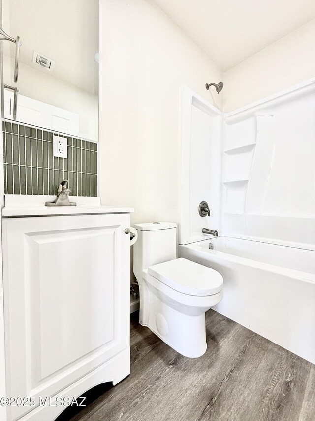 full bathroom featuring vanity, shower / bathing tub combination, hardwood / wood-style floors, and toilet