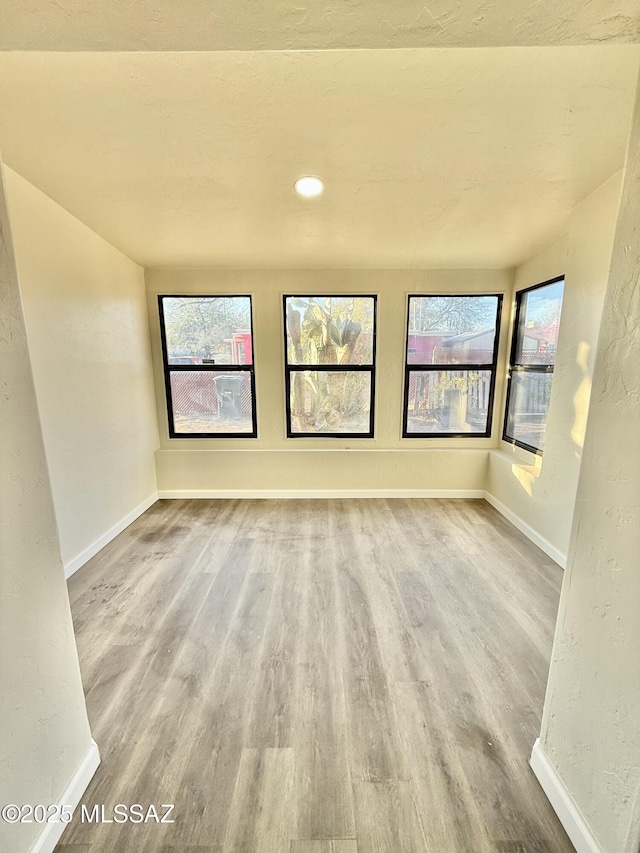 unfurnished room with light hardwood / wood-style floors