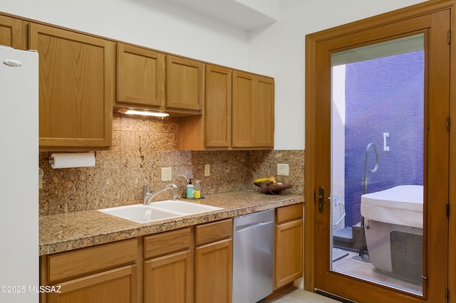 kitchen with white fridge, sink, stainless steel dishwasher, and backsplash