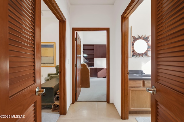 corridor featuring light tile patterned floors