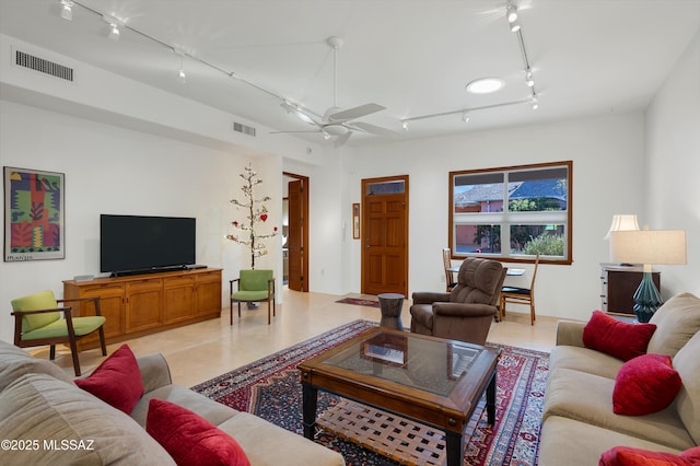 living room with light tile patterned flooring, ceiling fan, and track lighting