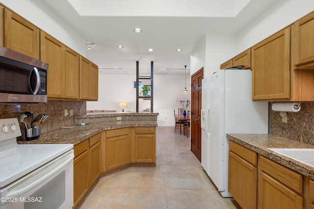 kitchen featuring white appliances, backsplash, hanging light fixtures, light tile patterned flooring, and kitchen peninsula