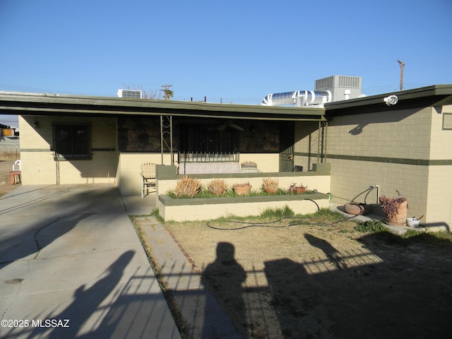 back of house with central air condition unit