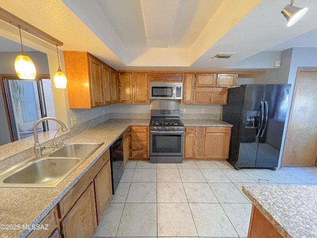 kitchen featuring sink, hanging light fixtures, black appliances, light tile patterned flooring, and a raised ceiling