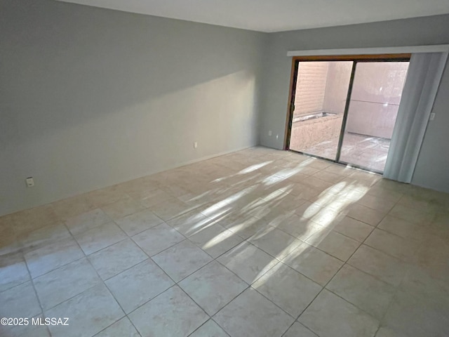 unfurnished room with light tile patterned flooring