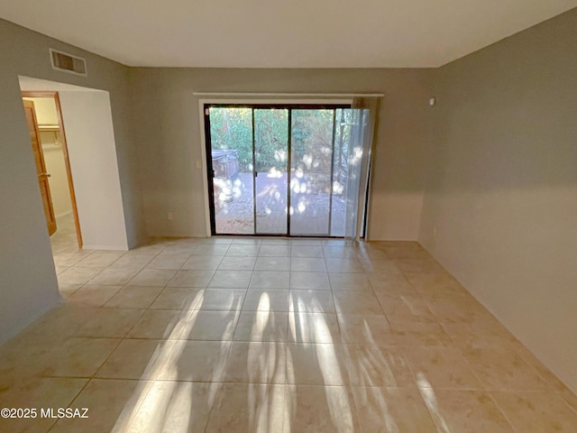 spare room featuring light tile patterned flooring