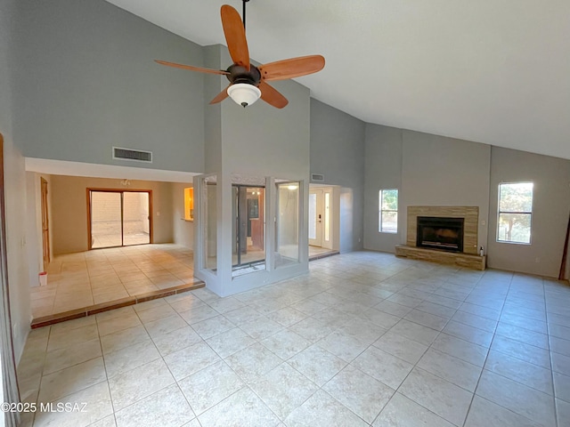 unfurnished living room featuring vaulted ceiling, light tile patterned floors, and ceiling fan