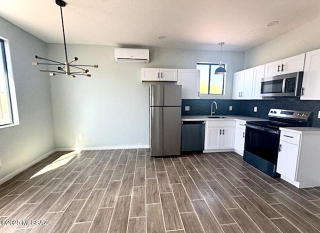 kitchen with appliances with stainless steel finishes, a sink, a wall mounted air conditioner, backsplash, and dark wood-style floors